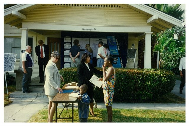 People outside of a neighborhood open house in 1996