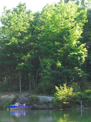 Crew uses pedal boat to sample habitat on a lake.