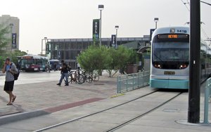 light rail train in a station with people