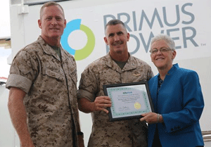 Two Marine Corp members standing with Gina McCarthy holding a plaque.