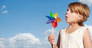 Child outside with a toy pinwheel