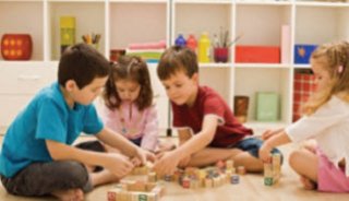 young children playing in a small classroom