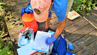 citizen scientist conducting water monitoring