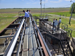People standing on a water treatment deck