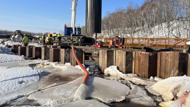 Sheet piles are being removed by lage machine