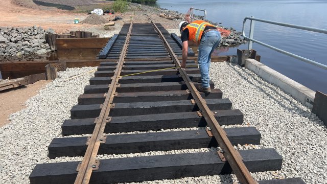 The new railroad section at the Wire Mill Pond bridge is being inspected prior to completion.  
