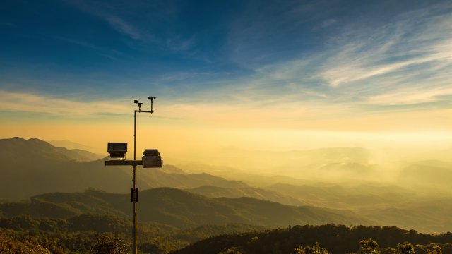 Air monitor at sunrise on a hilltop.