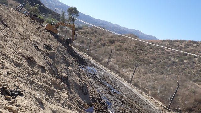 Chiquita Canyon Landfill image displaying security fence and earth mover at work