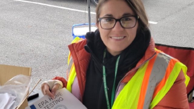 A female EPA employee wearing a winter jacket and a yellow vest.