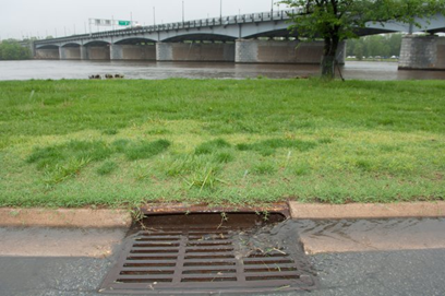 a storm drain in front of a river