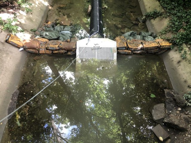 Spiral coated media filter installed at a storm sewer outfall.