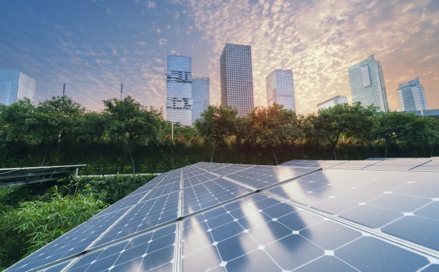 Picture of solar panels with city skyline in background