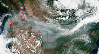 Image of wildfire smoke across the United States. Actively burning areas outlined in red.