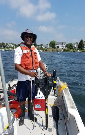 Dr. Darryl Keith, research oceanographer, holding a hyperspectral radiometer which was used to measure the optical character of the underwater light field over seagrass meadows.