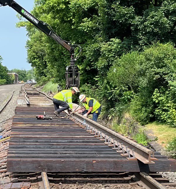 Workers on the train tracks working