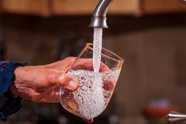 Image of a glass of water being filled under the tap