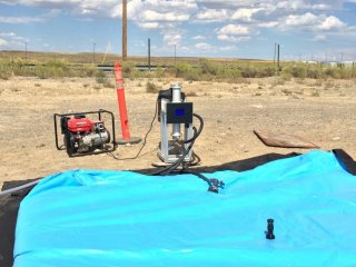 The Solstreme X35 UV treatment unit, shown at the Water Security Test Bed, with a blue bladder tank in front of it.