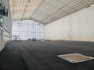 Interior of tented Segment 3 building showing pavement spread thoughout.