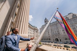 Administrator Michael Regan raising the Pride flag at EPA HQ