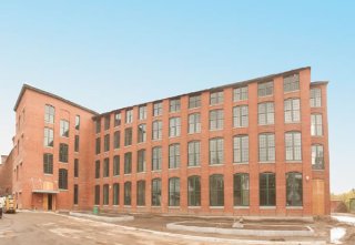 Exterior photo of redeveloped Ludlow Mills building