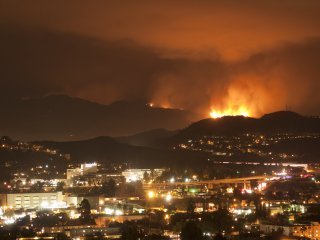 image of nighttime fire and smoke around the buildings