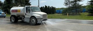 Water truck spraying ground for dust control in east palestine Ohio