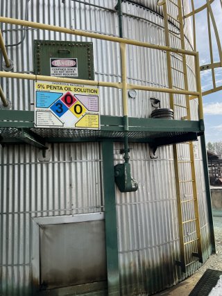Exterior chemical storage tank showing hazard information for penta.