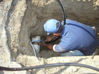 Man fixing underground pipe.