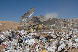 compacting truck in landfill