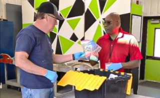 Photo of a customer carefully disposing of multiple vape pens at an HHW collection site.