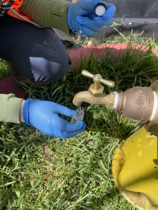 Water samples being taken from a spigot that has been added to a fire hydrant.