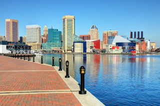 View of Baltimore inner harbor with brick walkway, water and skyline
